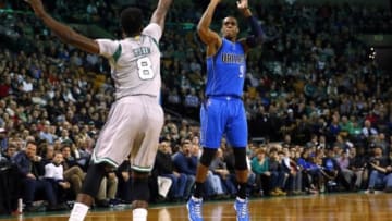 Jan 2, 2015; Boston, MA, USA; Dallas Mavericks guard Rajon Rondo (9) shoots over Boston Celtics forward Jeff Green (8) during the first quarter at TD Garden. Mandatory Credit: Winslow Townson-USA TODAY Sports