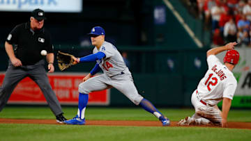 ST. LOUIS, MO - APRIL 9: Paul DeJong #12 of the St. Louis Cardinals steals second base against Enrique Hernandez #14 of the Los Angeles Dodgers in the seventh inning as umpire Bill Miller #26 looks on at Busch Stadium on April 9, 2019 in St. Louis, Missouri. (Photo by Dilip Vishwanat/Getty Images)