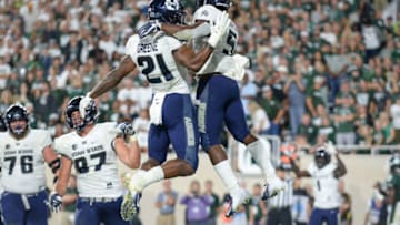 EAST LANSING, MI - AUGUST 31: Utah State Aggies running back Darwin Thompson (5) and wide receiver Jalen Greene celebrate Thompson's touchdown during a non-conference college football game between Michigan State and Utah State on August 31, 2018, at Spartan Stadium in East Lansing, MI.(Photo by Adam Ruff/Icon Sportswire via Getty Images)