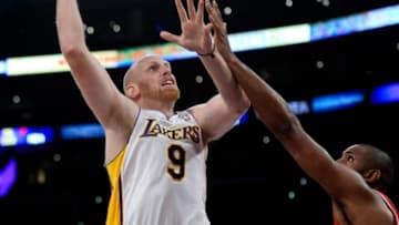 Nov 3, 2013; Los Angeles, CA, USA; Los Angeles Lakers center Chris Kaman (9) shoots over Atlanta Hawks center Al Horford (15) during the second half at Staples Center. Mandatory Credit: Robert Hanashiro-USA TODAY Sports