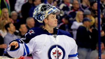 COLUMBUS, OH - APRIL 6: Eric Comrie #1 of the Winnipeg Jets watches a replay after letting in a goal while making his NHL debut during the game against the Columbus Blue Jackets on April 6, 2017 at Nationwide Arena in Columbus, Ohio. (Photo by Kirk Irwin/Getty Images)