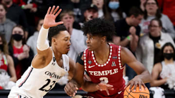 Temple Owls guard Jahlil White dribbles the ball against Cincinnati Bearcats guard Mika Adams-Woods at Fifth Third Arena. Getty Images.