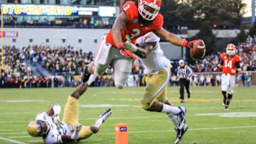 Nov 30, 2013; Atlanta, GA, USA; Georgia Bulldogs running back Todd Gurley (3) dives into the end zone for a touchdown over Georgia Tech Yellow Jackets cornerback D.J. White (28) and linebacker Brandon Watts (11) in the first half at Bobby Dodd Stadium. Mandatory Credit: Daniel Shirey-USA TODAY Sports