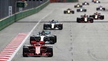BAKU, AZERBAIJAN - APRIL 29: Sebastian Vettel of Germany driving the (5) Scuderia Ferrari SF71H leads Lewis Hamilton of Great Britain driving the (44) Mercedes AMG Petronas F1 Team Mercedes WO9 and the rest of the field during the Azerbaijan Formula One Grand Prix at Baku City Circuit on April 29, 2018 in Baku, Azerbaijan. (Photo by Mark Thompson/Getty Images)