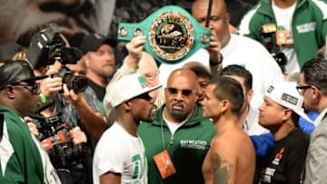 Sep 12, 2014; Las Vegas, NV, USA; Floyd Mayweather (left) and Marcos Maidana face off during the the weigh-in for their WBC Superwelter weight title fight MGM Grand Garden Arena. Mandatory Credit: Jayne Kamin-Oncea-USA TODAY Sports