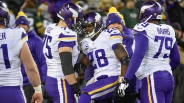 Jan 3, 2016; Green Bay, WI, USA; Minnesota Vikings running back Adrian Peterson (28) greets offensive tackle Matt Kalil (75) before a game against the Green Bay Packers at Lambeau Field. Mandatory Credit: Benny Sieu-USA TODAY Sports