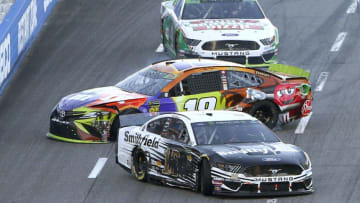 MARTINSVILLE, VIRGINIA - OCTOBER 27: Aric Almirola, driver of the #10 Smithfield Ford, and Kyle Busch, driver of the #18 M&M's Halloween Toyota, are involved in an on-track incident during the Monster Energy NASCAR Cup Series First Data 500 at Martinsville Speedway on October 27, 2019 in Martinsville, Virginia. (Photo by Brian Lawdermilk/Getty Images)