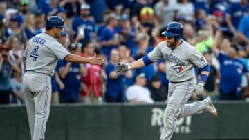 SEATTLE, WA - AUGUST 3: Russell Martin #55 of the Toronto Blue Jays is congratulated by third base coach Luis Rivera after hitting solo home run off of starting pitcher Marco Gonzales #32 of the Seattle Mariners during the fourth inning of a game at Safeco Field on August 3, 2018 in Seattle, Washington. (Photo by Stephen Brashear/Getty Images)