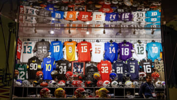 A vendor selling football jerseys watches Super Bowl LVII between the Kansas City Chiefs and Philadelphia Eagles at State Farm Stadium on February 12, 2023 in Glendale, Arizona (Photo by Tasos Katopodis/Getty Images)