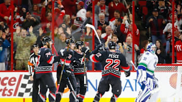 Dec 13, 2016; Raleigh, NC, USA; Carolina Hurricanes forward Victor Rask (49) celebrates his third period goal with teammates defensemen Jaccob Slavin (74) forward Jeff Skinner (53) and Carolina Hurricanes defensemen Brett Pesce (22) against he Vancouver Canucks at PNC Arena. The Carolina Hurricanes defeated the Vancouver Canucks 8-6. Mandatory Credit: James Guillory-USA TODAY Sports