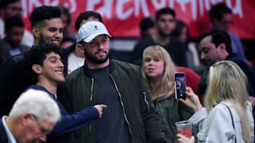 LOS ANGELES, CA - JANUARY 02: Heisman Trophy winning Oklahoma Sooners quarterback Baker Mayfield and Emily Wilkinson attend a basketball game between the Los Angeles Clippers and the Memphis Grizzlies, one day after losing to Georgia in the College Football Playoff semifinals, at Staples Center on January 2, 2018 in Los Angeles, California. NOTE TO USER: User expressly acknowledges and agrees that, by downloading and or using this photograph, User is consenting to the terms and conditions of the Getty Images License Agreement. (Photo by Kevork Djansezian/Getty Images)