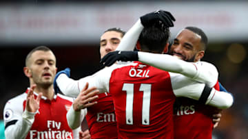 LONDON, ENGLAND - JANUARY 20: Alexandre Lacazette of Arsenal celebrates scoring his side's fourth goal with Mesut Ozil and team mates during the Premier League match between Arsenal and Crystal Palace at Emirates Stadium on January 20, 2018 in London, England. (Photo by Clive Mason/Getty Images)