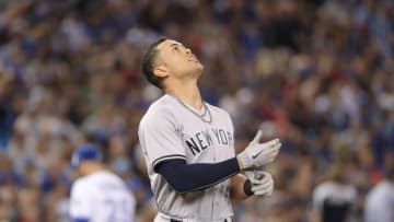 TORONTO, ON - JUNE 5: Giancarlo Stanton #27 of the New York Yankees reacts after striking out to end the top of the third inning during MLB game action against the Toronto Blue Jays at Rogers Centre on June 5, 2018 in Toronto, Canada. (Photo by Tom Szczerbowski/Getty Images)