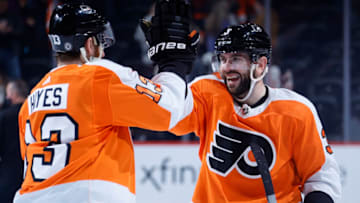 PHILADELPHIA, PENNSYLVANIA - DECEMBER 14: Keith Yandle #3 of the Philadelphia Flyers (R) celebrates with teammate Kevin Hayes #13 after they defeated the New Jersey Devils at Wells Fargo Center on December 14, 2021 in Philadelphia, Pennsylvania. (Photo by Tim Nwachukwu/Getty Images)