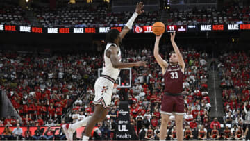 Nov 9, 2022; Louisville, Kentucky, USA; Bellarmine Knights guard Ben Johnson (33) shoots against Louisville Cardinals forward Jae'Lyn Withers (24) during the first half at KFC Yum! Center. Mandatory Credit: Jamie Rhodes-USA TODAY Sports