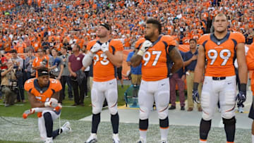 Sep 8, 2016; Denver, CO, USA; Denver Broncos inside linebacker Brandon Marshall (54) kneels during the national anthem next to defensive end Jared Crick (93) and defensive tackle Billy Winn (97) and defensive tackle Adam Gotsis (99) before the game against the Carolina Panthers at Sports Authority Field at Mile High. Mandatory Credit: Ron Chenoy-USA TODAY Sports