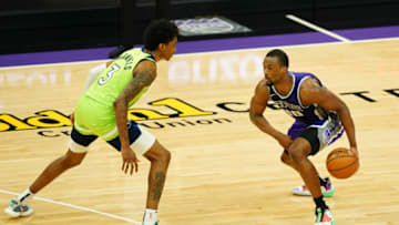 Harrison Barnes of the Sacramento Kings handles the ball against Jaden McDaniels of the Minnesota Timberwolves. (Photo by Daniel Shirey/Getty Images)