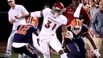 Riverdale's Elijah Herring (31) runs the ball as Blackman's Elijah Pitts (12) moves in for a tackle on Friday, Sept. 25, 2020, at Blackman.2 Blackman V Riverdale