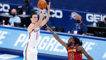 OKC Thunder forward Aleksej Pokusevski (17) shoots as Cleveland Cavaliers forward Taurean Prince (12) defends him. Mandatory Credit: Alonzo Adams-USA TODAY Sports.