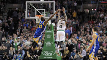 Mar 1, 2015; Boston, MA, USA; Boston Celtics guard Isaiah Thomas (4) shoots a three point shot past Golden State Warriors forward Draymond Green (23) in the final seconds during the second half at TD Garden. Mandatory Credit: Bob DeChiara-USA TODAY Sports
