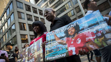 NEW YORK, NY - AUGUST 23: Activists rally in support of NFL quarterback Colin Kaepernick outside the offices of the National Football League on Park Avenue, August 23, 2017 in New York City. During the NFL season last year, Kaepernick caused controversy by kneeling during the National Anthem at games to protest racial oppression and police brutality. Kaepernick is currently a free agent and some critics and analysts claim NFL teams don't want to sign him due to his public display of his political beliefs. (Photo by Drew Angerer/Getty Images)
