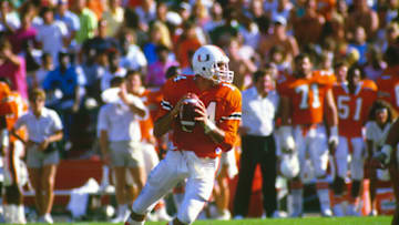 MIAMI, FL - NOVEMBER 1: Vinny Testaverde #14 of the Miami Hurricanes drops back to pass against the Florida State Seminoles during an NCAA football game November 1, 1986 at Joe Robbie Stadium in Miami, Florida. (Photo by Focus on Sport/Getty Images)