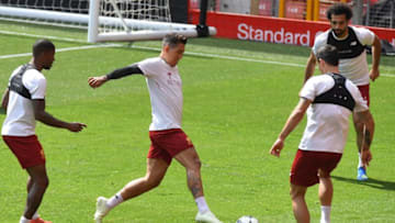 Liverpool's Dutch midfielder Georginio Wijnaldum (L), Liverpool's Brazilian midfielder Roberto Firmino (2L), Liverpool's Croatian defender Dejan Lovren (2R) and Liverpool's Egyptian midfielder Mohamed Salah attend a training session and media day at Anfield stadium in Liverpool, north west England on May 21, 2018, ahead of their UEFA Champions League final football match against Real Madrid in Kiev on May 26. (Photo by Paul ELLIS / AFP) (Photo credit should read PAUL ELLIS/AFP/Getty Images)