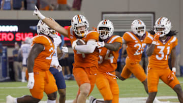 Sep 3, 2021; Blacksburg, Virginia, USA; Virginia Tech Hokies linebacker Dax Hollifield (4) celebrates after he intercepts a pass with teammates linebacker Alan Tisdale (34) and defensive back Nasir Peoples (31) during the second half against the North Carolina Tar Heels against the North Carolina Tar Heels at Lane Stadium. Mandatory Credit: Reinhold Matay-USA TODAY Sports
