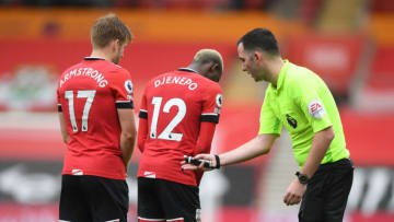 SOUTHAMPTON, ENGLAND - OCTOBER 04: Chris Kavanagh match referee speaks with Stuart Armstrong of Southampton and Moussa Djenepo of Southampton during the Premier League match between Southampton and West Bromwich Albion at St Mary's Stadium on October 04, 2020 in Southampton, England. Sporting stadiums around the UK remain under strict restrictions due to the Coronavirus Pandemic as Government social distancing laws prohibit fans inside venues resulting in games being played behind closed doors. (Photo by Mike Hewitt/Getty Images)