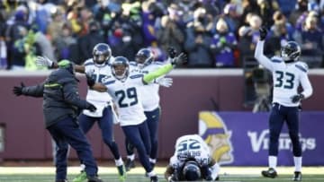 Jan 10, 2016; Minneapolis, MN, USA; Seattle Seahawks players including Earl Thomas (29) and Richard Sherman (25) and Kelcie McCray (33) celebrate after Minnesota Vikings kicker Blair Walsh (not pictured) missed a field goal in the fourth quarter in a NFC Wild Card playoff football game at TCF Bank Stadium. Mandatory Credit: Bruce Kluckhohn-USA TODAY Sports