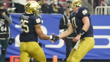 Jan 1, 2022; Glendale, Arizona, USA; Notre Dame Fighting Irish running back Chris Tyree (25) greets quarterback Jack Coan (17) after scoring a touchdown against the Oklahoma State Cowboys in the first half in the PlayStation Fiesta Bowl at State Farm Stadium. Mandatory Credit: Rob Schumacher-Arizona RepublicNcaa Football Playstation Fiesta Bowl Oklahoma State At Notre Dame
