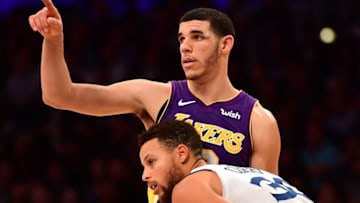LOS ANGELES, CA - NOVEMBER 29: Lonzo Ball #2 of the Los Angeles Lakers signals as he is guarded by Stephen Curry #30 of the Golden State Warriors during a 127-123 Warriors win in overtime at Staples Center on November 29, 2017 in Los Angeles, California. (Photo by Harry How/Getty Images)