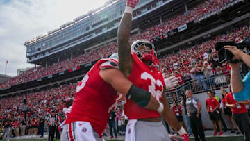 Sep 16, 2023; Columbus, Ohio, USA; Ohio State Buckeyes running back TreVeyon Henderson (32) celebrates socring a touchdown with offensive lineman Carson Hinzman (75) during the first half of the NCAA football game against the Western Kentucky Hilltoppers at Ohio Stadium.