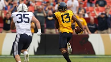 LANDOVER, MD - SEPTEMBER 24: Cornerback Rasul Douglas #13 of the West Virginia Mountaineers runs back an interception for a touchdown past Brayden El-Bakri #35 of the Brigham Young Cougars during the first half at FedExField on September 24, 2016 in Landover, Maryland. (Photo by Patrick Smith/Getty Images)