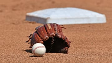 Omaha, NE - JUNE 24: A general view of a baseball and glove in the the field, prior to game one of the College World Series Championship Series between the Michigan Wolverines and Vanderbilt Commodores on June 24, 2019 at TD Ameritrade Park Omaha in Omaha, Nebraska. (Photo by Peter Aiken/Getty Images)