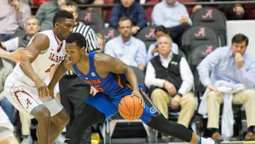 Jan 10, 2017; Tuscaloosa, AL, USA; Florida Gators forward Keith Stone (25) dribbles the ball against Alabama Crimson Tide forward Bola Olaniyan (21) at Coleman Coliseum. The Gators won 80-67. Mandatory Credit: Marvin Gentry-USA TODAY Sports