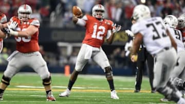 Jan 12, 2015; Arlington, TX, USA; Ohio State Buckeyes quarterback Cardale Jones (12) throws during the fourth quarter in the 2015 CFP National Championship Game at AT&T Stadium. Ohio State Buckeyes defeated Oregon Ducks 42-20. Mandatory Credit: Tommy Gilligan-USA TODAY Sports