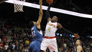 Nov 9, 2015; Atlanta, GA, USA; Atlanta Hawks forward Paul Millsap (4) attempts a dunk over Minnesota Timberwolves center Karl-Anthony Towns (32) in the fourth quarter at Philips Arena. The Timberwolves defeated the Hawks 117-107. Mandatory Credit: Brett Davis-USA TODAY Sports