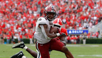 ATHENS, GEORGIA - OCTOBER 12: Rico Dowdle #5 of the South Carolina Gamecocks is tackled by Azeez Ojulari #13 of the Georgia Bulldogs during the second overtime of their 20-17 win at Sanford Stadium on October 12, 2019 in Athens, Georgia. (Photo by Kevin C. Cox/Getty Images)