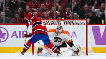 Nov 19, 2022; Montreal, Quebec, CAN; Montreal Canadiens center Nick Suzuki (14) scores against Philadelphia Flyers goalie Carter Hart (79) during shootout at Bell Centre. Mandatory Credit: David Kirouac-USA TODAY Sports