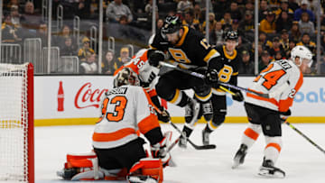 Jan 16, 2023; Boston, Massachusetts, USA; Philadelphia Flyers goaltender Samuel Ersson (33) makes a save as Boston Bruins left wing Nick Foligno (17) leaps to get out of the way of the shot during the third period at TD Garden. Mandatory Credit: Winslow Townson-USA TODAY Sports