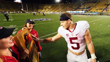 Nov 19, 2016; Berkeley, CA, USA; Stanford Cardinal running back Christian McCaffrey (5) touches the Stanford Axe after a win over the California Golden Bears at Memorial Stadium. Stanford defeated California 45-31. Mandatory Credit: Kelley L Cox-USA TODAY Sports