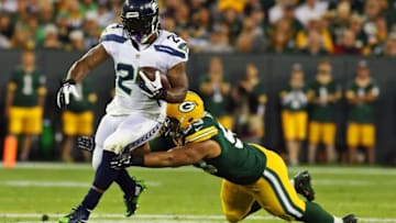 Sep 20, 2015; Green Bay, WI, USA; Seattle Seahawks running back Marshawn Lynch (24) carries the ball by a diving Green Bay Packers outside linebacker Nick Perry (53) during the first quarter at Lambeau Field. Packers won 27-17. Mandatory Credit: Ray Carlin-USA TODAY Sports