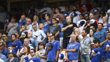 LOS ANGELES, CALIFORNIA - JUNE 28: Fans stand during the national anthem before the game between the Los Angeles Dodgers and the San Francisco Giants at Dodger Stadium on June 28, 2021 in Los Angeles, California. (Photo by Meg Oliphant/Getty Images)