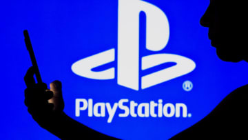BRAZIL - 2022/05/02: In this photo illustration, the PlayStation logo is seen in the background of a silhouetted woman holding a mobile phone. (Photo Illustration by Rafael Henrique/SOPA Images/LightRocket via Getty Images)