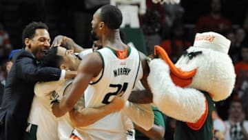 Feb 9, 2016; Coral Gables, FL, USA; Teammates swarm Miami Hurricane guard Angel Rodriguez (2nd from left) as the Hurricanes defeat the Pittsburgh Panthers 65-63 at BankUnited Center. Mandatory Credit: Robert Duyos-USA TODAY Sports