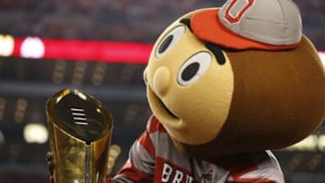 Jan 12, 2015; Arlington, TX, USA; Ohio State Buckeyes mascot Brutus plays with the College Playoff trophy after the game against the Oregon Ducks for the 2015 CFP National Championship Game at AT&T Stadium. Mandatory Credit: Matthew Emmons-USA TODAY Sports