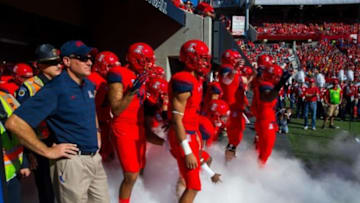 Nov 28, 2014; Tucson, AZ, USA; Arizona Wildcats head coach Rich Rodriguez (left) with his players prior to the game against the Arizona State Sun Devils during the 88th annual territorial cup at Arizona Stadium. The Wildcats defeated the Sun Devils 42-35 to win the Pac-12 south title. Mandatory Credit: Mark J. Rebilas-USA TODAY Sports