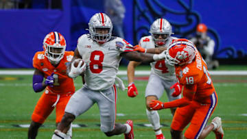 Jan 1, 2021; New Orleans, LA, USA; Ohio State Buckeyes running back Trey Sermon (8) grabs the face mask of Clemson Tigers safety Joseph Charleston (18) as he runs upfield during the fourth quarter of the College Football Playoff semifinal at the Allstate Sugar Bowl in the Mercedes-Benz Superdome in New Orleans on Friday, Jan. 1, 2021. Ohio State won 49-28. Mandatory Credit: Adam Cairns-USA TODAY Sports