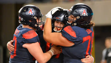 Sep 28, 2019; Tucson, AZ, USA; Arizona Wildcats offensive lineman Josh McCauley (50) quarterback Grant Gunnell (17) (middle) and offensive lineman Donovan Laie (78) (right) celebrate after beating the UCLA Bruins at Arizona Stadium. Mandatory Credit: Casey Sapio-USA TODAY Sports